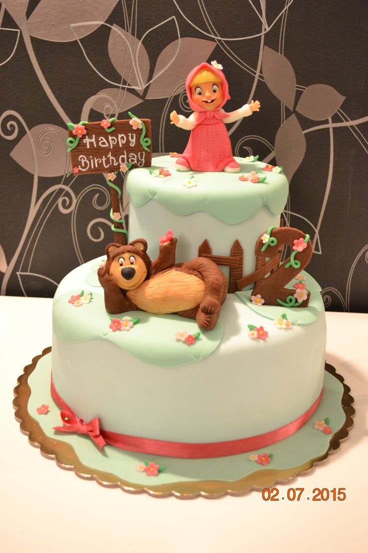 there is a birthday cake with a girl on top and bears in the bottom tier