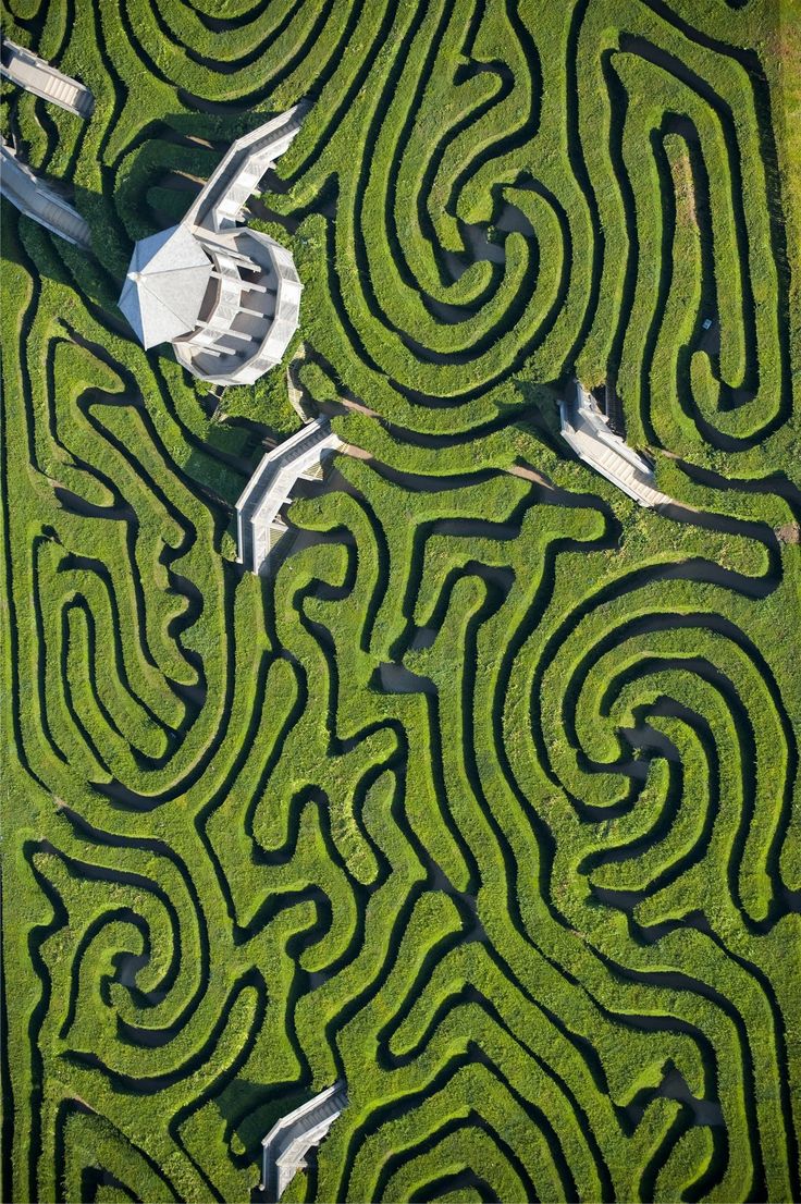 an aerial view of a maze in the grass