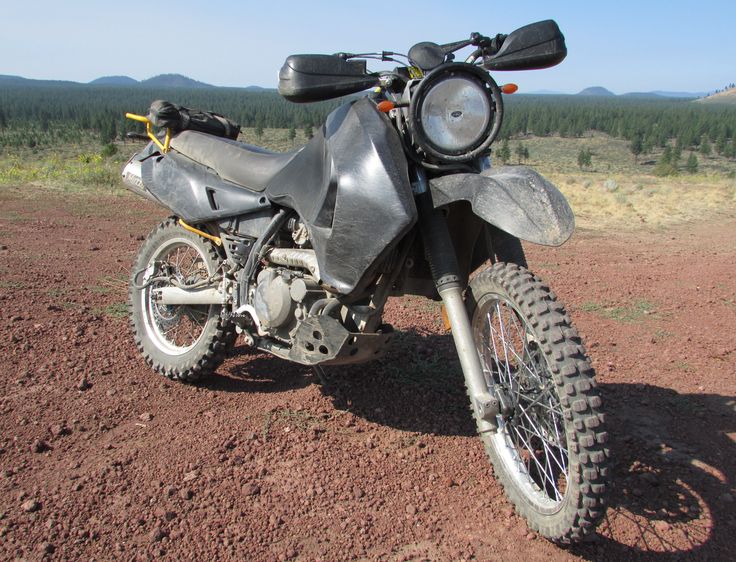 a dirt bike parked on top of a dirt field