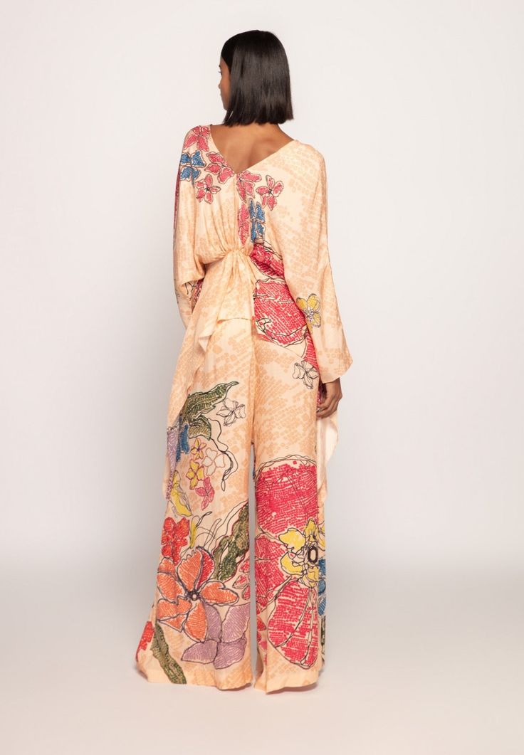 Editor's Note Elevate your style with this marigold bandhani print, part-hand micro-pleated kaftan. It boasts a drawstring waist, adjustable drawstring sleeves, and customisable side slits for a versatile and chic look. It comes with matching palazzo Asymmetric Blouse, Bandhani Print, Asymmetrical Blouse, Indian Fabric, Satin Color, Floral Print Blouses, Blouse Online, Indian Design, Handmade Clothes