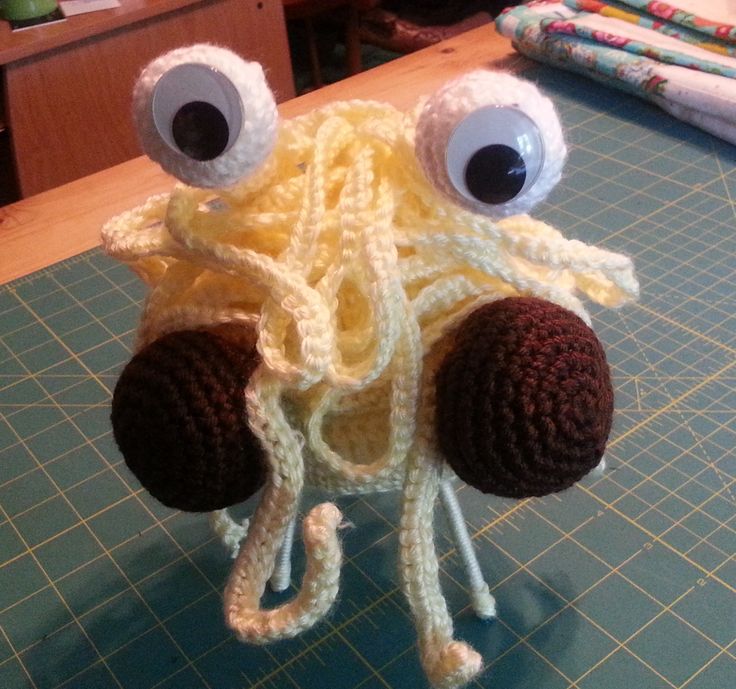 a crocheted octopus hat with googly eyes