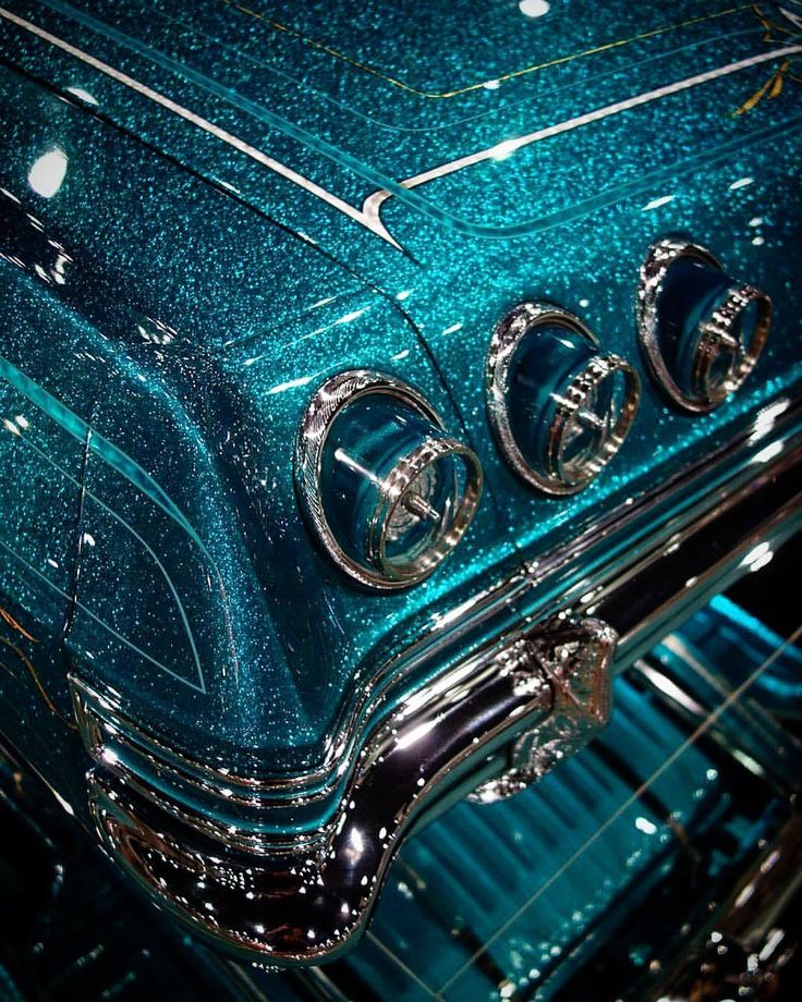 the inside of an old fashioned car with shiny blue paint and chrome trimmings