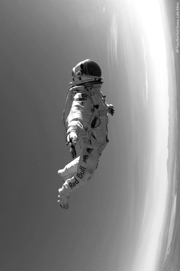 an astronaut floating in the air with his feet up