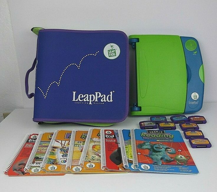 the leappad is next to some books and games