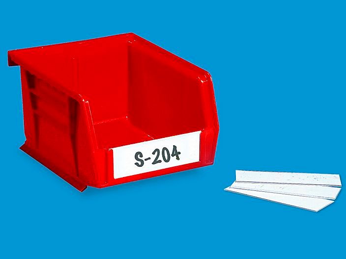 a red plastic container with two pieces of paper next to it on a blue background