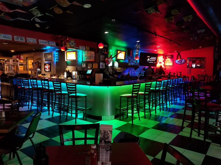 a brightly lit bar with lots of chairs