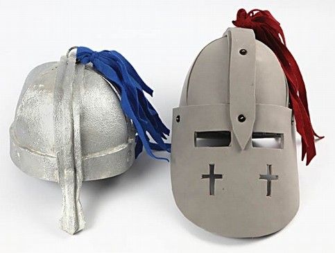 two helmets with red, white and blue ribbons attached to them are sitting side by side