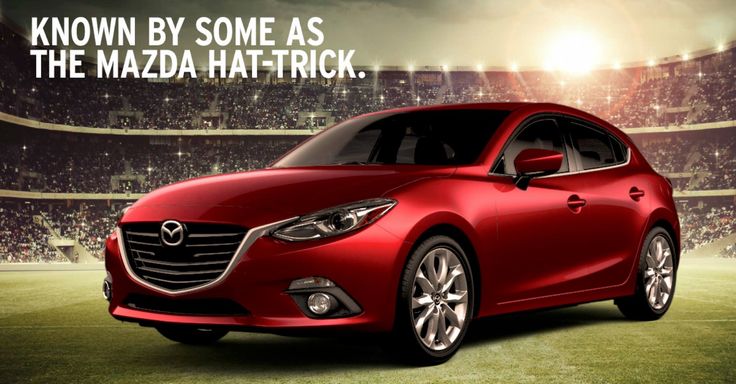 a red car parked in front of a stadium with the words know by some as the mazda hit - trick