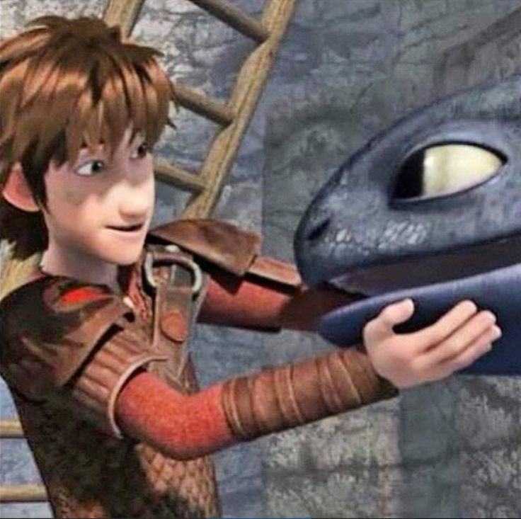 a young boy is playing with a large blue creature in the animated movie how to train your dragon