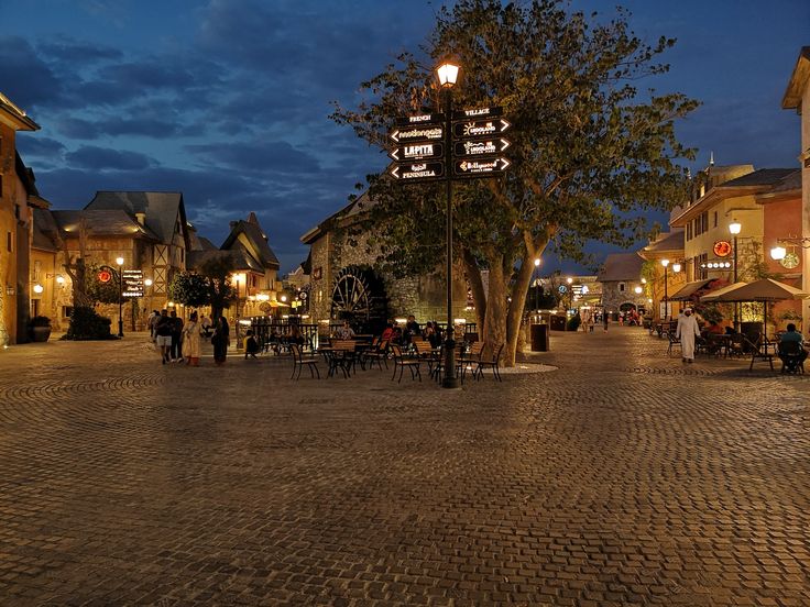 a cobblestone street lined with shops and restaurants