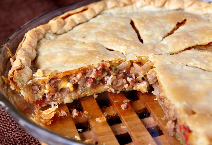 a pie with meat and cheese is cut in half