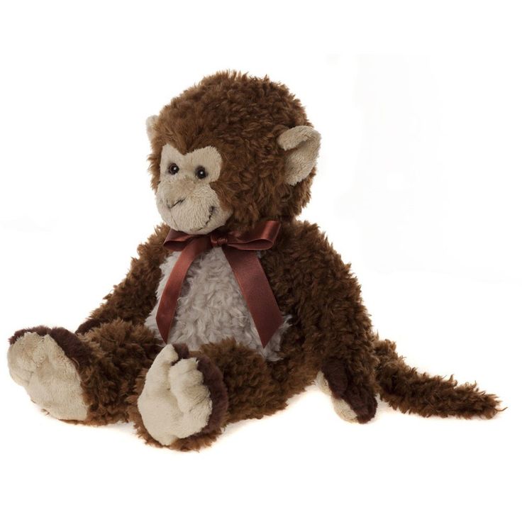 a stuffed monkey with a red bow on its neck and feet, sitting in front of a white background