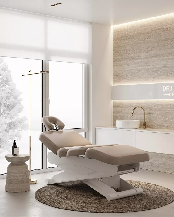 a white chair sitting on top of a rug in front of a large window next to a sink