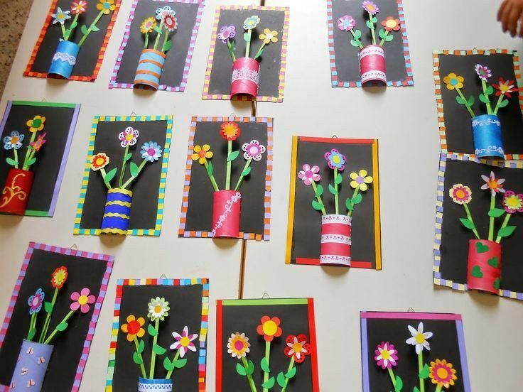 paper flowers are placed on top of black and white cards with colored papers attached to them