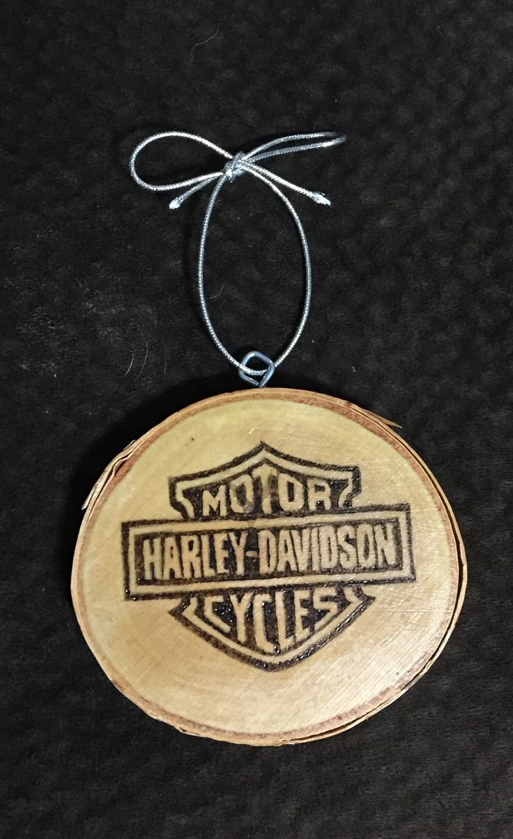 a wooden ornament with the words harley davidson cycles on it hanging from a string