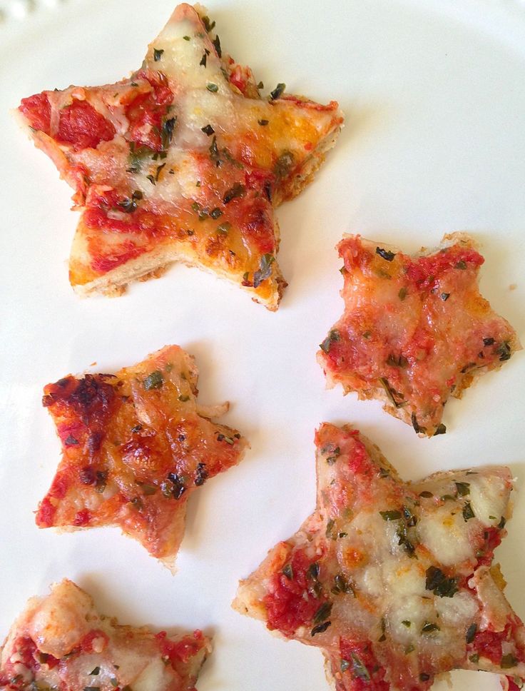 four pieces of pizza sitting on top of a white plate