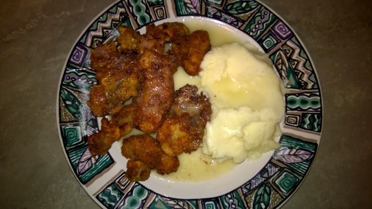 a plate topped with meat and mashed potatoes