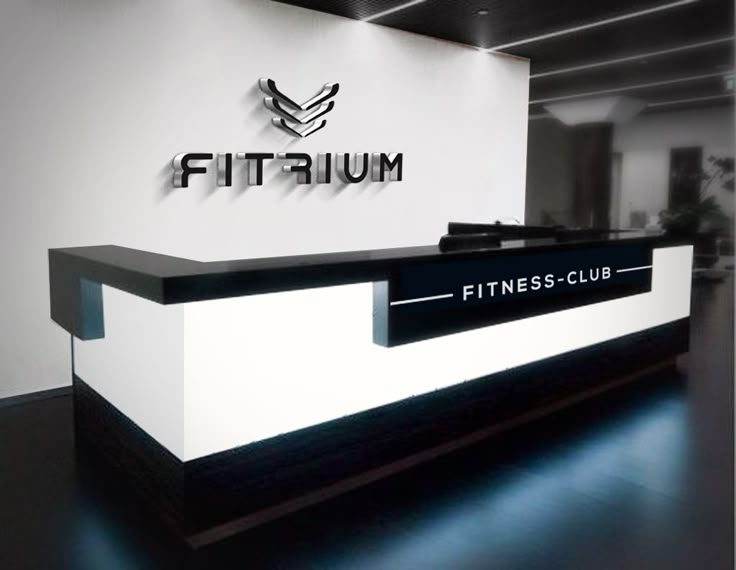 a white and black reception desk with the word fitrum on it