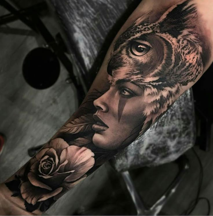 an owl with a woman's face and flowers on her arm is shown in this tattoo