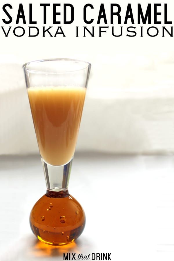 a glass filled with liquid sitting on top of a table