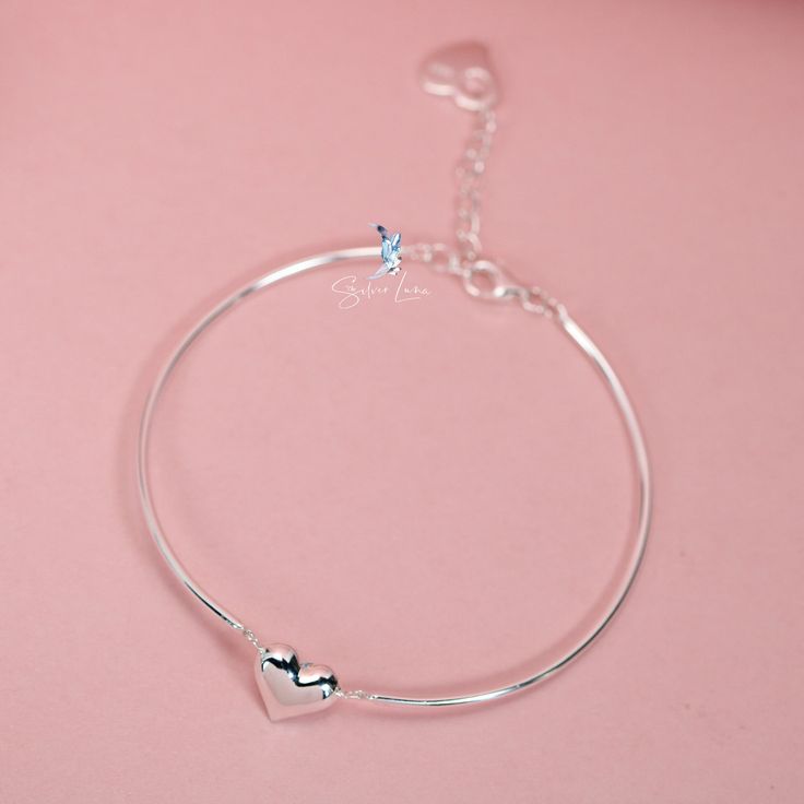 This beautifully crafted bracelet showcases two linked bangle pieces, complete with an adjustable chain and a charming heart-shaped charm. Made of high-quality 925 sterling silver, it makes for an exceptional Valentine's gift for your special someone. Treat your loved one to a piece of jewelry that is as stunning as it is meaningful. The Solid silver Valentine heart half bangle bracelet is a symbol of your love, beautifully crafted from 925 sterling silver and complete with an adjustable chain f Heart Shape Bracelet, Heart Bangle Bracelet, Chain Heart, For Your Love, Valentine's Gift, Valentine Gift, Bracelet Silver, Valentine Heart, Jewelry Plate