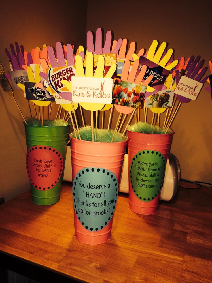 there are many cupcake sticks in the cups on the table with some sayings