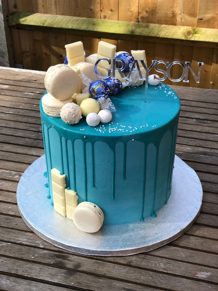 a blue cake sitting on top of a wooden table