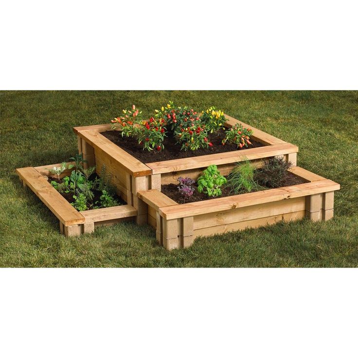 three wooden raised planters with plants growing in them