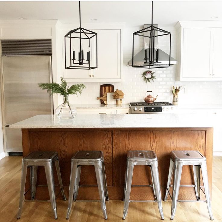 three stools sit in front of a kitchen island