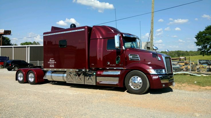 a red semi truck parked in a parking lot