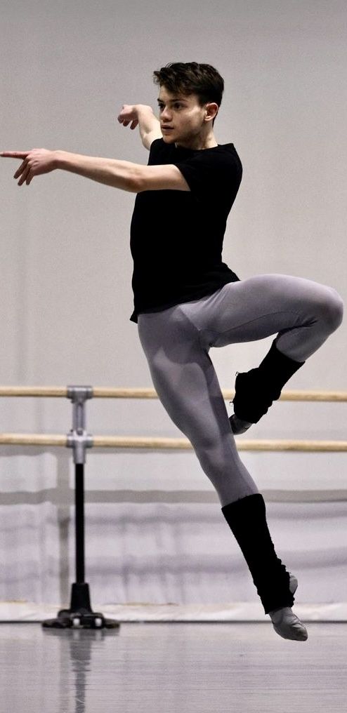 a young man is practicing his ballet moves