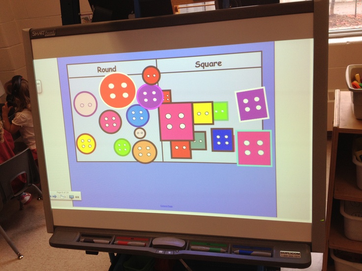 a computer screen displaying a board with different shapes and sizes on it in a classroom