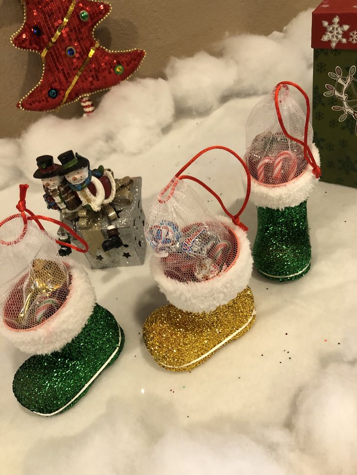 three christmas ornaments are sitting in the snow