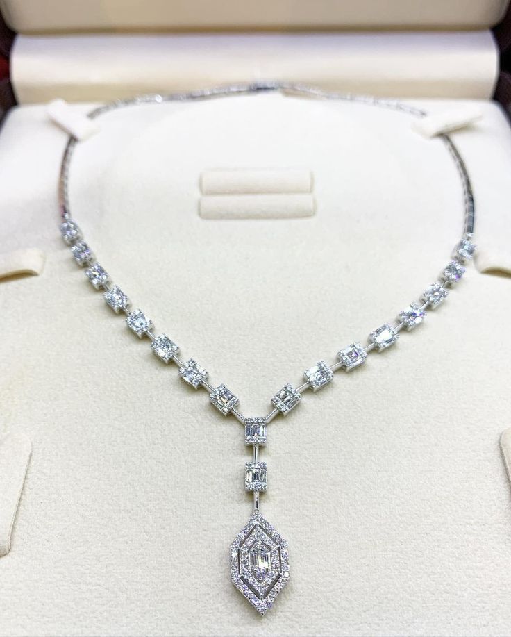 She'll never tire of wearing this unique and sophisticated Illusion diamond necklace. Stunning in 18K solid white gold, this breathtaking line of shimmering round diamonds. So elegant, this 16.0-inch diamond necklace will take her breath away. Radiant with 3.53 cts. t.w. of diamonds and buffed to a brilliant luster, this glamorous keepsake secures with a box clasp. The setting design make the diamonds look much bigger than they are. When worn, the diamonds in the front look like half a carat eme Formal Emerald Cut Diamond Necklace, White Emerald Cut Diamond Necklace For Formal Occasion, Platinum Baguette Cut Diamond Necklace For Wedding, Baguette Cut Diamond Necklace In Platinum For Wedding, Baguette Cut Platinum Diamond Necklace For Wedding, Luxury Silver Necklace Gia Certified, Exquisite Emerald Cut Diamond Necklace, Diamond White Baguette Cut Diamond Necklace For Formal Occasions, Formal Baguette Cut Diamond White Diamond Necklace