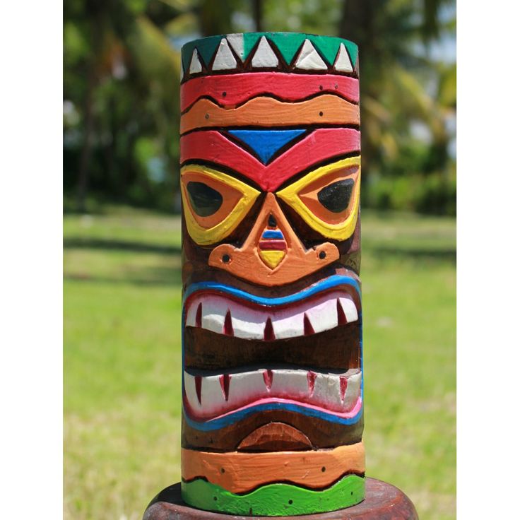 a totem pole in the shape of a tiki with colorful designs on it