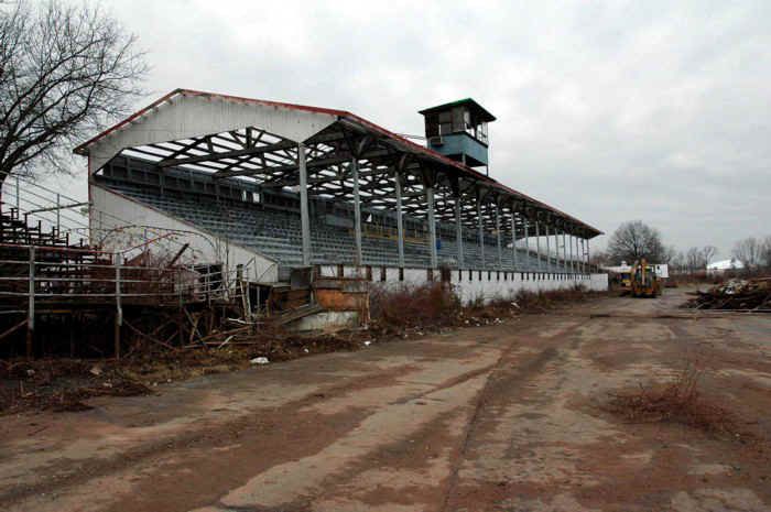 an abandoned building with a clock tower in the middle of it's roof and scaffolding