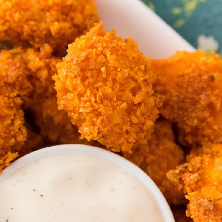 fried food item with dip in small white bowl