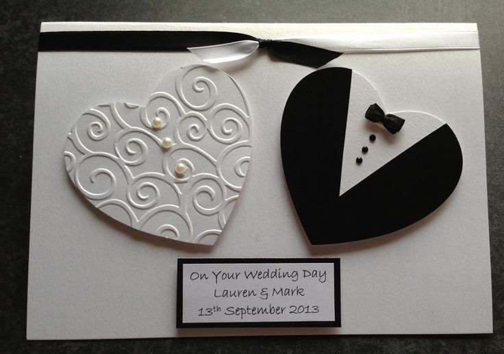 a wedding card with an ornament on it and a heart shaped brooch