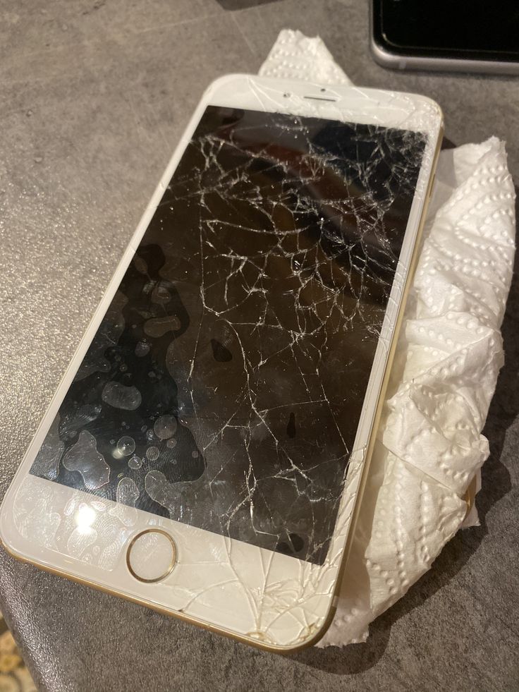 an iphone that has been broken and sitting on the ground