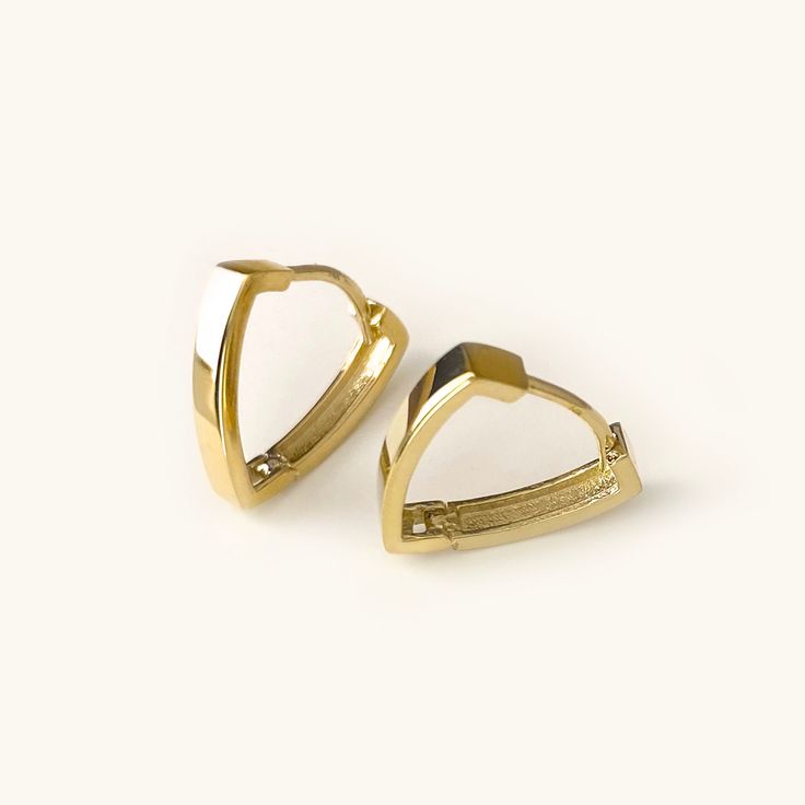 One pair of cool and modern hoop earrings handcrafted in 14K solid gold. The Triangle shape gives basic hoops a fresh new look. Ships within 3 business days. - Earring size: 12mm - Earring width: 2.5mm - Inner diameter: 10mm - Sold as A Pair. - Made in 14 karat gold. - Stamp with 14K. Tarnish Resistant 14k Gold Huggie Hoop Earrings, 14k Gold Tarnish Resistant Huggie Hoop Earrings, Minimalist White Gold-plated Huggie Earrings, Minimalist White Gold Plated Huggie Earrings, Modern Tarnish-resistant Hoop Huggie Earrings, 14k Gold Huggie Hoop Earrings Tarnish Resistant, Modern Yellow Gold Sterling Silver Cartilage Earrings, Modern Hypoallergenic Yellow Gold Huggie Earrings, Modern Tarnish Resistant Huggie Hoop Earrings