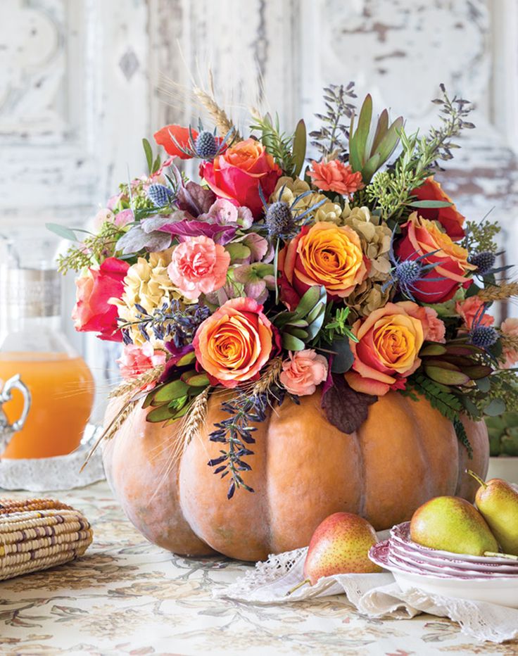 a magazine cover with flowers and fruit on the front, featuring an image of a pumpkin