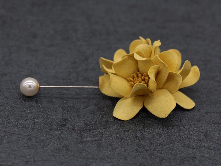 Classy Yellow Lapel Flower: This relatively smaller flower has a silver pin attached to it with a white bead on the other end. bowselectie.com Shade Of Yellow, Flower Lapel, Flower Lapel Pin, Lapel Flower, Hijab Pins, Silver Pin, Dark Yellow, Yellow Fabric, Shades Of Yellow