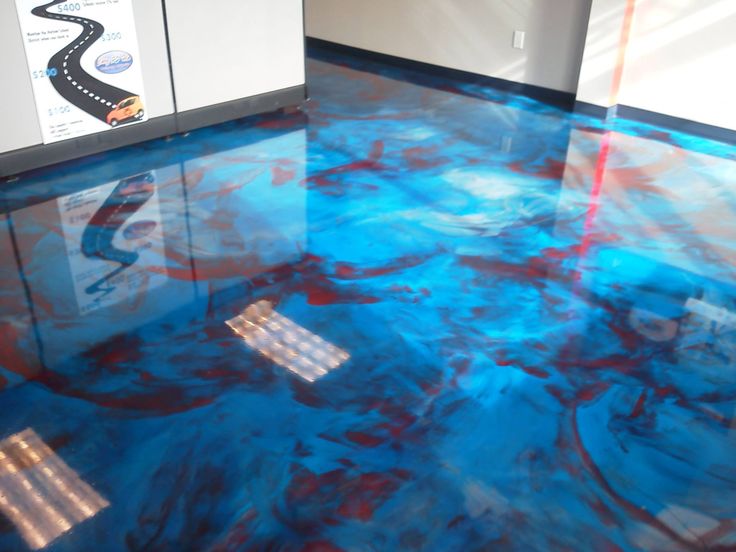 a blue floor with red and white paint on it