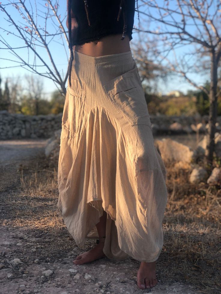 ♡ Your clothing speaks a lot about you and with this unconventional boho skirt, your style statement will be put across well. Made of a breathable and comfortable 100% cotton fabric, the skirt features an elasticated back for adjustability and pockets on the side. The asymmetric silhouette makes it unique and you'll find yourself going back to this skirt again and again. Available in different color options and sizes for you to choose from. Please pick your preference from the drop-down menu abo Beige Long Ruffled Skirt, Fitted Beige Skirt For Festivals, Bohemian Relaxed-fit Summer Skirt, Bohemian Summer Wrap Skirt With Lining, Bohemian Summer Lined Wrap Skirt, Bohemian Long Relaxed Skirt, Bohemian Asymmetrical Maxi Skirt, Festival Asymmetrical Skirt, Bohemian Summer Maxi Skirt With Gathered Detail