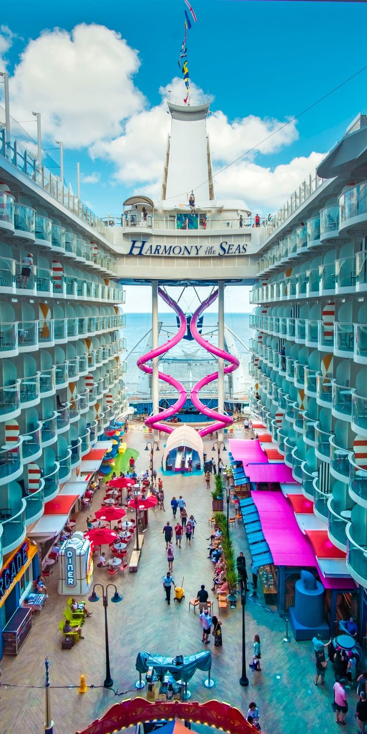 the inside of a cruise ship with many people walking around and looking at their surroundings