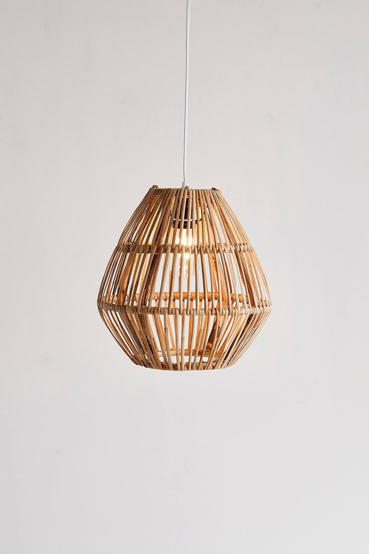 a light that is hanging from a ceiling in a room with white walls and flooring