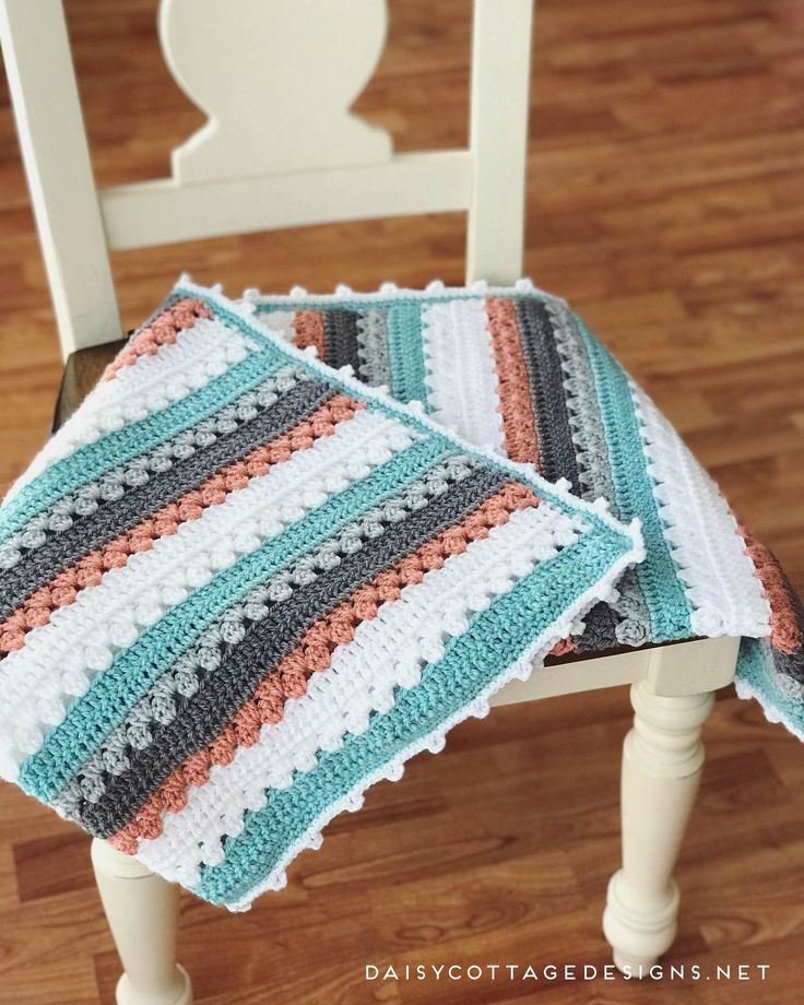 two crocheted placemats sitting on top of a wooden chair in a room