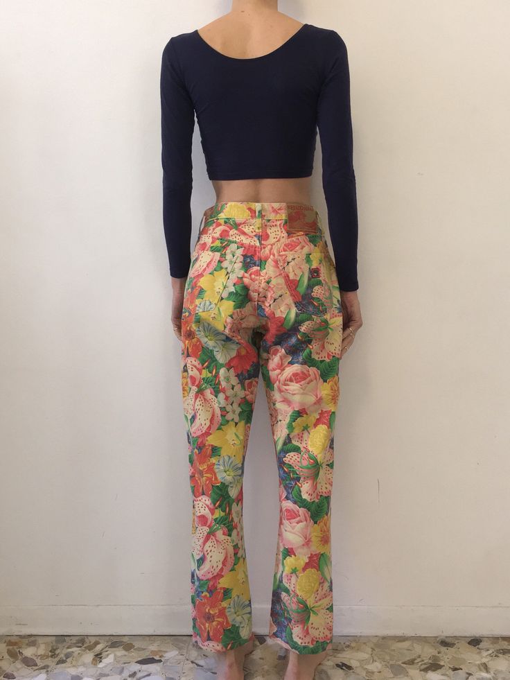 Multi color floral 1980s Kenzo Jeans! All over gorgeous floral print. Super cute summer style paired with a little crop top and beach hair. Fabric is a cotton denim. High waisted fit with five pockets and a tapered leg. Kenzo buttons up the fly - each copper button has the Kenzo logo. Kenzo face logo on back pocket. Label Kenzo Jeans, Miyuki, size US29, 100% cotton, please turn inside out and wash cool delicate and drip dry. Very good vintage condition - please note that the outside leg seam has Retro Multicolor Spring Jeans, Multicolor Retro Spring Jeans, Multicolor Floral Print Pants For Spring, Summer Floral Print Pants, Spring Multicolor Floral Print Pants, Retro Printed Bottoms For Spring, Retro Multicolor Summer Jeans, Summer Casual Printed Jeans, Casual Summer Printed Jeans