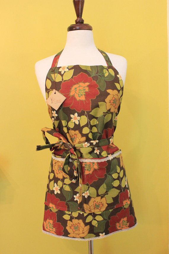 a mannequin wearing an apron with flowers on it