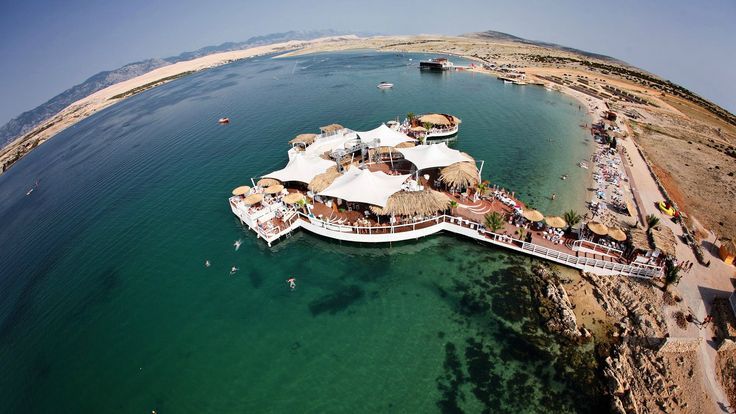 an aerial view of a resort on the water